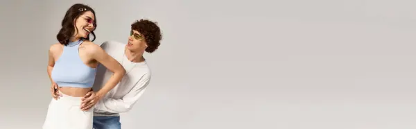 A young couple in trendy spring outfits share a fun, romantic moment together. — Stock Photo