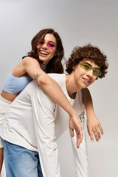 A stylish young couple shares a joyful moment, showcasing their fashion sense and affection. — Stock Photo