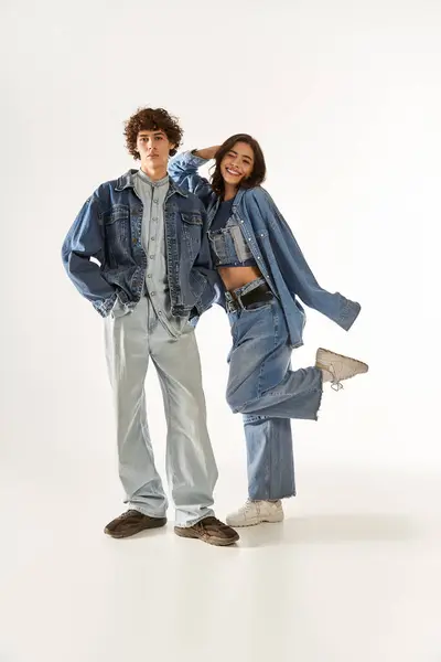 A young couple expresses their love through playful poses while dressed in matching denim outfits. — Stock Photo