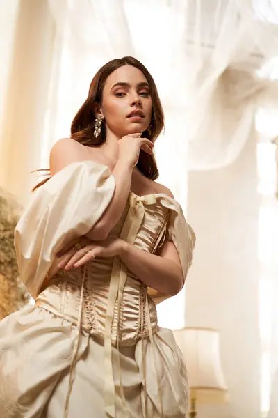 A graceful young woman poses in an elegant vintage dress, exuding timeless beauty and bliss. — Stock Photo