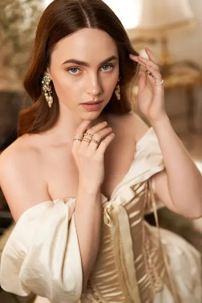 A beautiful young woman in an elegant dress captures timeless vintage aesthetics with grace. — Stock Photo