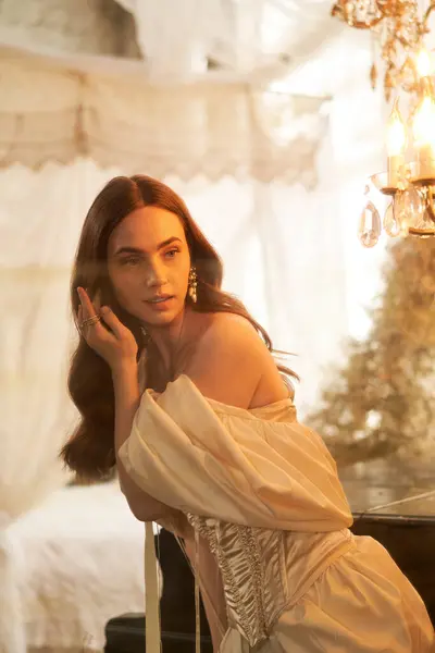 A beautiful young woman in an elegant vintage dress radiates bliss in a dreamy, softly lit space. — Stock Photo