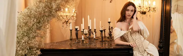 A blissful young woman in an elegant vintage dress poses gracefully amid soft candlelight, banner — Stock Photo
