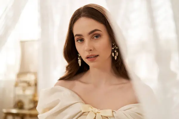 A stunning young woman captivates with her vintage dress and graceful demeanor in soft light. — Stock Photo
