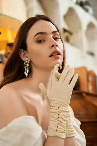 A young woman embodies vintage charm, wearing an elegant dress and gloves while posing gracefully. — Stock Photo
