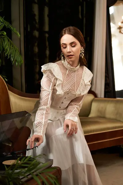 Elegant young woman in a vintage dress creates a tranquil vibe while enjoying music. — Stock Photo