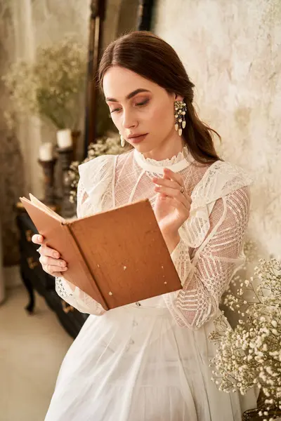A young woman in a lovely dress reads quietly in a cozy, vintage setting. — Stock Photo