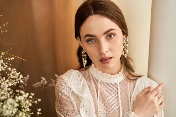 A beautiful young woman poses gracefully, showcasing her vintage style amidst airy blooms. — Stock Photo