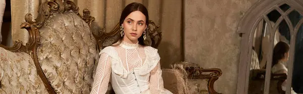 A young woman in a vintage dress exudes elegance in a lavish room, banner — Stock Photo