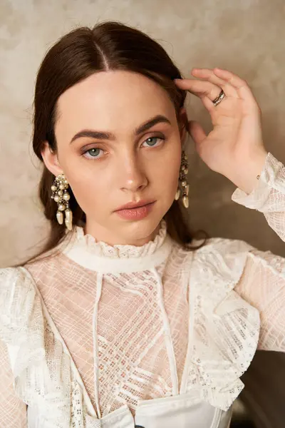 An elegant young woman showcases her style with intricate details in a vintage dress. — Stock Photo