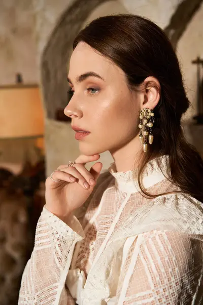 An elegant young woman showcases her beauty with vintage charm in a stylish decorated space. — Stock Photo