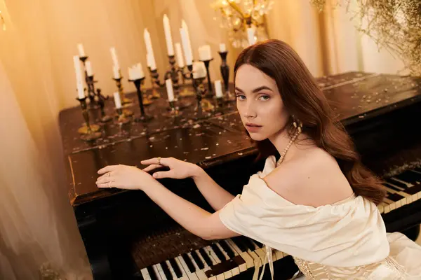 A captivating young woman displays grace and elegance beside a vintage piano adorned with candles. — Stock Photo
