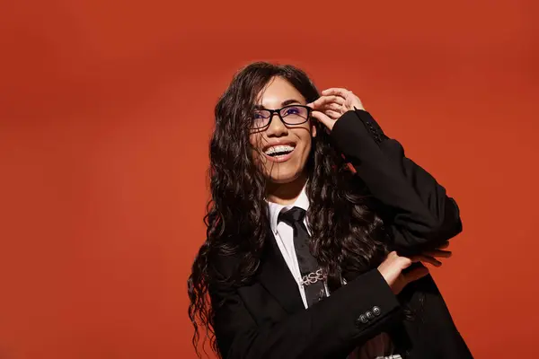 Smiling student with curly hair wears a stylish outfit while posing with confidence. — Stock Photo