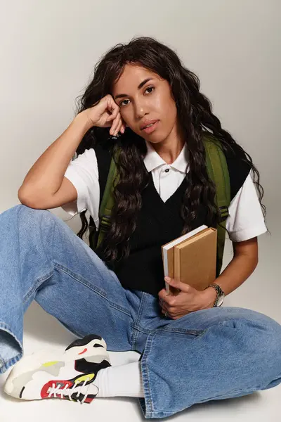 A vibrant scene with a young woman in casual wear, deep in thought. — Stock Photo