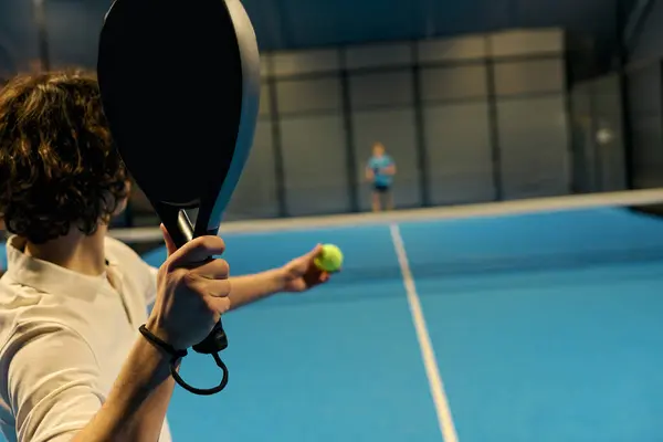 Young men showcase their skills in a thrilling game of padel, focused and competitive. — Stock Photo