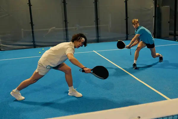 Two young sportsmen showcase their skills while playing an exciting game of padel. — Stock Photo