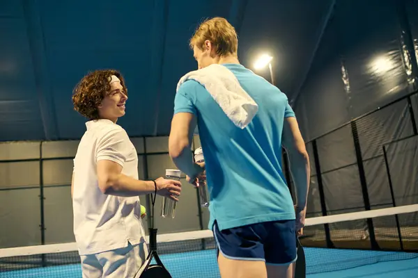 Exciting moment as sportsmen engage in a lively padel match, showcasing their skills. — Stock Photo