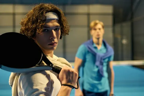 Two young men in sports gear practice padel, displaying their skills and determination. — Stock Photo