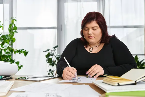 A talented individual sketches designs and ideas in a vibrant art studio surrounded by greenery. — Stock Photo