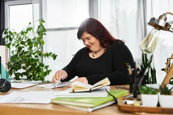 A stylish woman works on her art in a bright, green filled studio. — Stock Photo