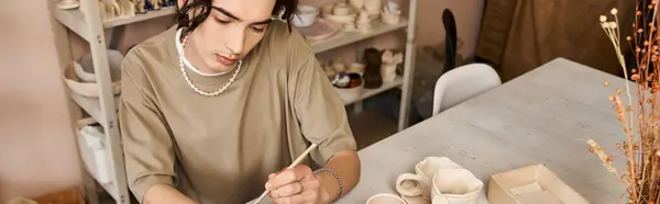A stylish man crafts unique ceramics in a bright, creative studio. — Stock Photo
