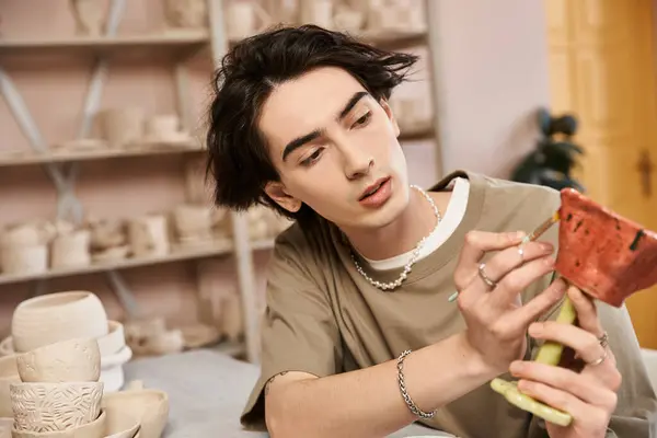 Stylish artist works meticulously on unique pottery in a vibrant ceramics workshop. — Stock Photo