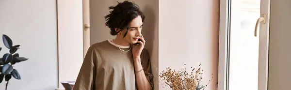 Handsome man chats on the phone surrounded by beautiful pottery and creative vibes in the studio — Stock Photo