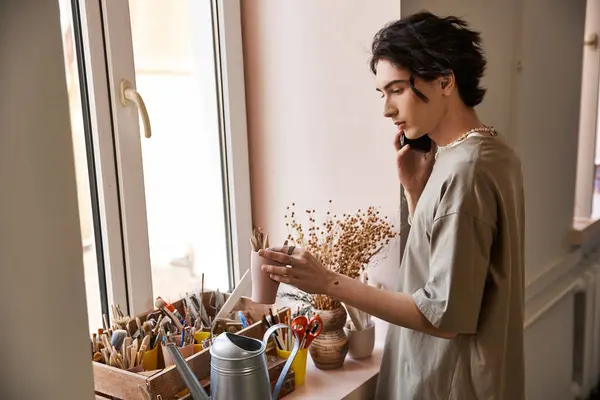 A fashionable man immersed in artistic pottery activities in a bright studio space. — Stock Photo