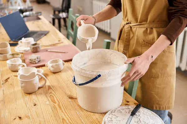 Handsome man in a pottery studio skillfully prepares clay for crafting unique pottery pieces. — Stock Photo