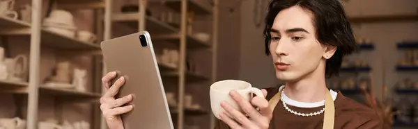 Stylish man engages with pottery while examining a creative design on his tablet. — Stock Photo