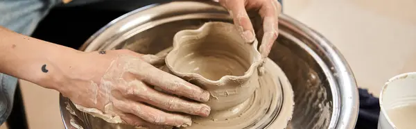 A stylish man passionately crafts a beautiful pottery piece while enjoying the creative atmosphere. — Stock Photo