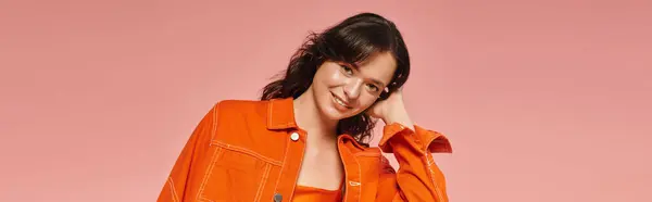 Young woman showcases her trendy fashion sense while smiling playfully in a vibrant setting. — Stock Photo