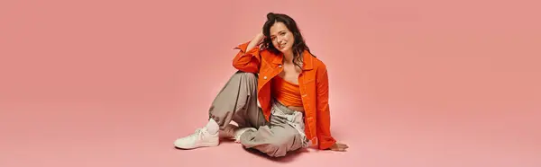 Young woman showcases her trendy outfit with a playful pose, radiating fashion forward energy. — Stock Photo