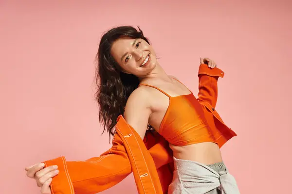 Joyful young woman displays unique fashion sense while enjoying a playful moment in the spotlight. — Stock Photo