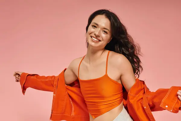 A young woman shows off her trendy, colorful outfit with a cheerful smile. — Stock Photo