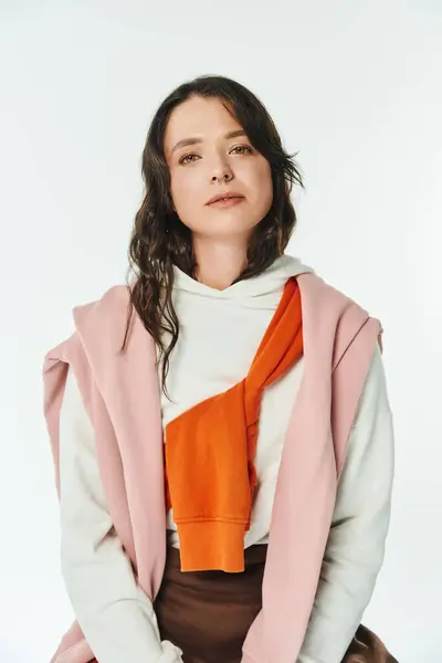 Young woman exhibits chic style through trendy attire and contrasting colors in a bright space. — Stock Photo