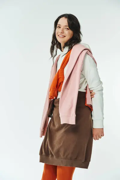 Young woman embraces trendy style with colorful layers in a bright, modern space. — Stock Photo