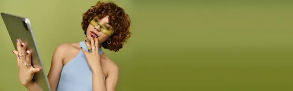 A young thoughtful woman with curly hair poses confidently in a stylish summer outfit, banner — Stock Photo