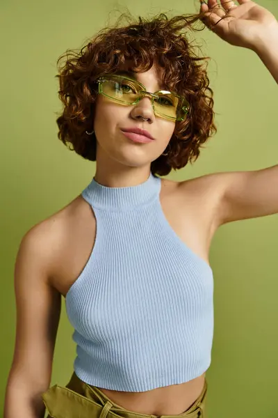 A young woman showcases her fashionable summer look with curly hair and playful accessories. — Stock Photo
