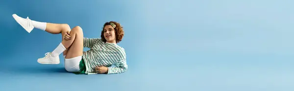 A young woman with curly hair poses playfully in a vibrant outfit, showcasing her joyful style, banner — Stock Photo