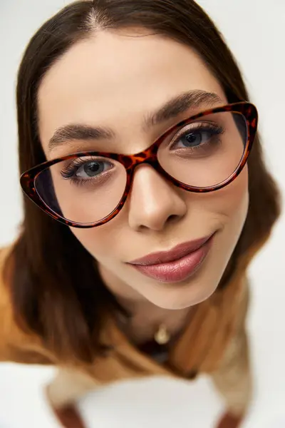Confident young woman flaunts vibrant fashion and chic glasses for a stylish look. — стокове фото