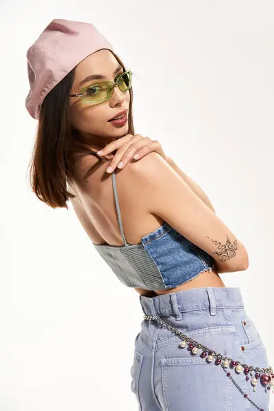 Confident young woman in trendy attire captures attention with bold colors and unique accessories — стокове фото
