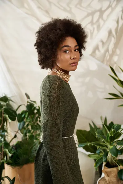 Young woman enjoys an intimate moment surrounded by vibrant plants, radiating style. — Stock Photo