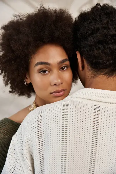 A young couple shares an intimate embrace, highlighting their affection in a cozy setting. — Stock Photo