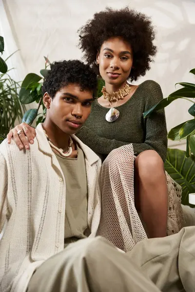 A young couple showcases their love in a serene setting filled with greenery. — Stock Photo