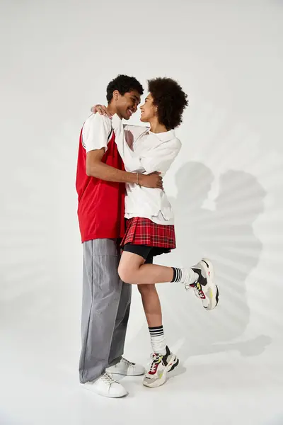 A couple embodies romance as they embrace in a chic environment, showcasing modern fashion. — Stock Photo