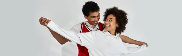 Stylish young couple shares a playful moment, radiating joy and warmth in their connection. — Stock Photo