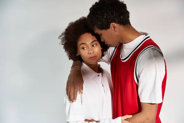 Loving couple embraces each other warmly, displaying deep affection and contemporary fashion. — Stock Photo