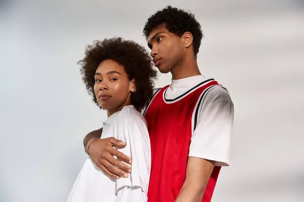 Young couple expresses their affection through stylish poses in a modern setting, radiating romance. — Stock Photo