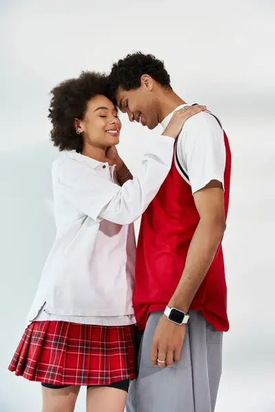 Joyful young couple embracing each other in a modern aesthetic environment radiating romance — Stock Photo